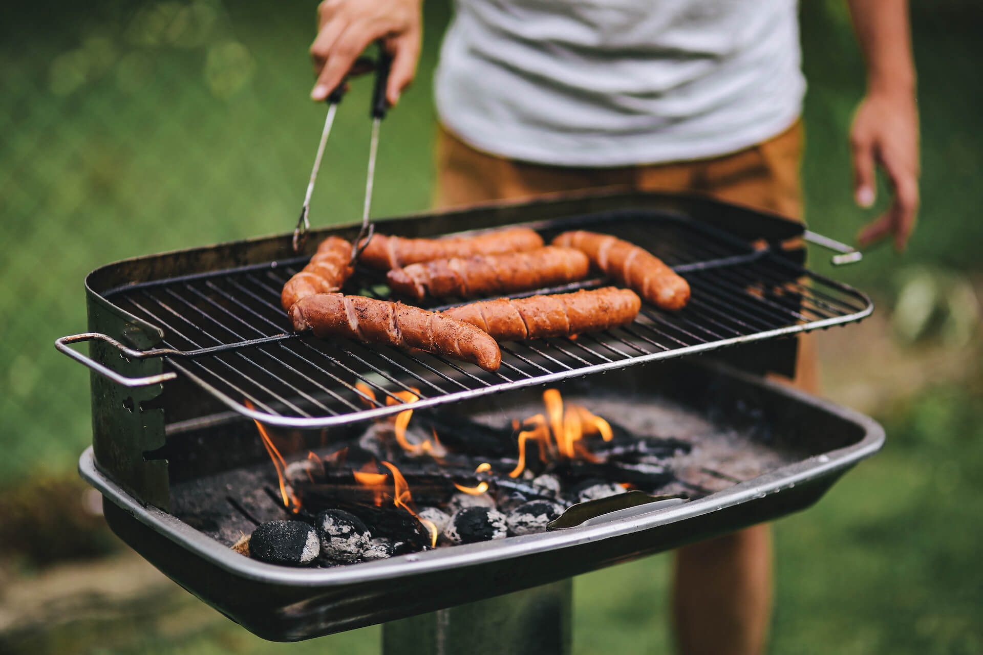 Bratwürste die auf einem Kohlegrill gebraten werden